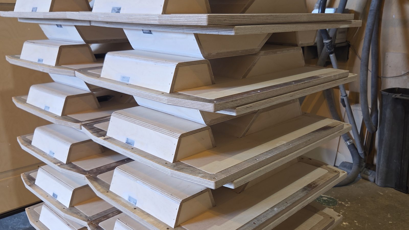 Stacked precision-cut speaker cabinet panels at the Sarivale workshop in Calne, Wiltshire.