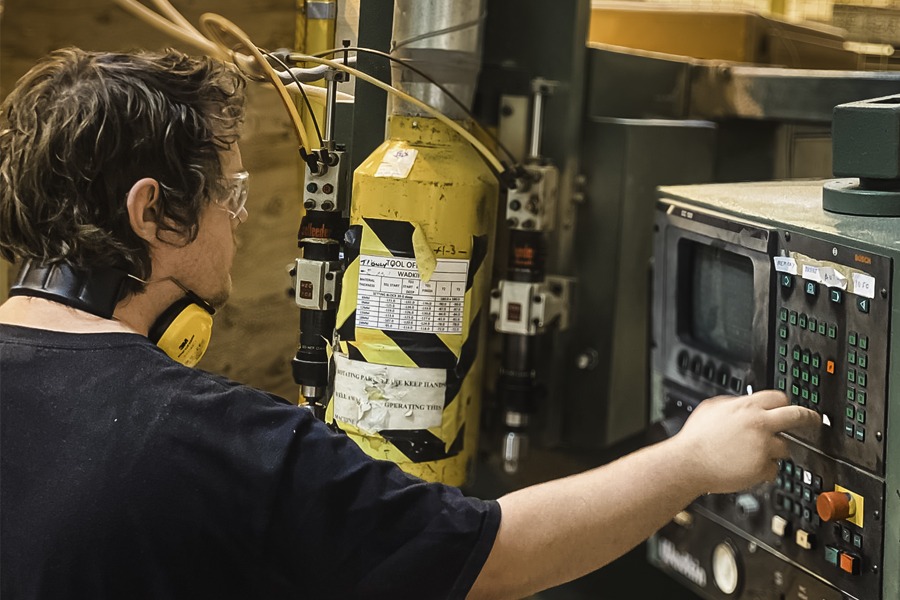 A craftsperson at work, machining timber to precise tolerances.