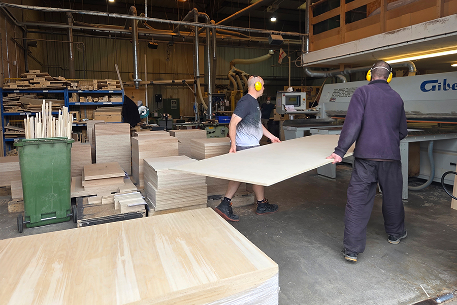 Baltic Birch sheets stacked in the workshop, awaiting inspection.