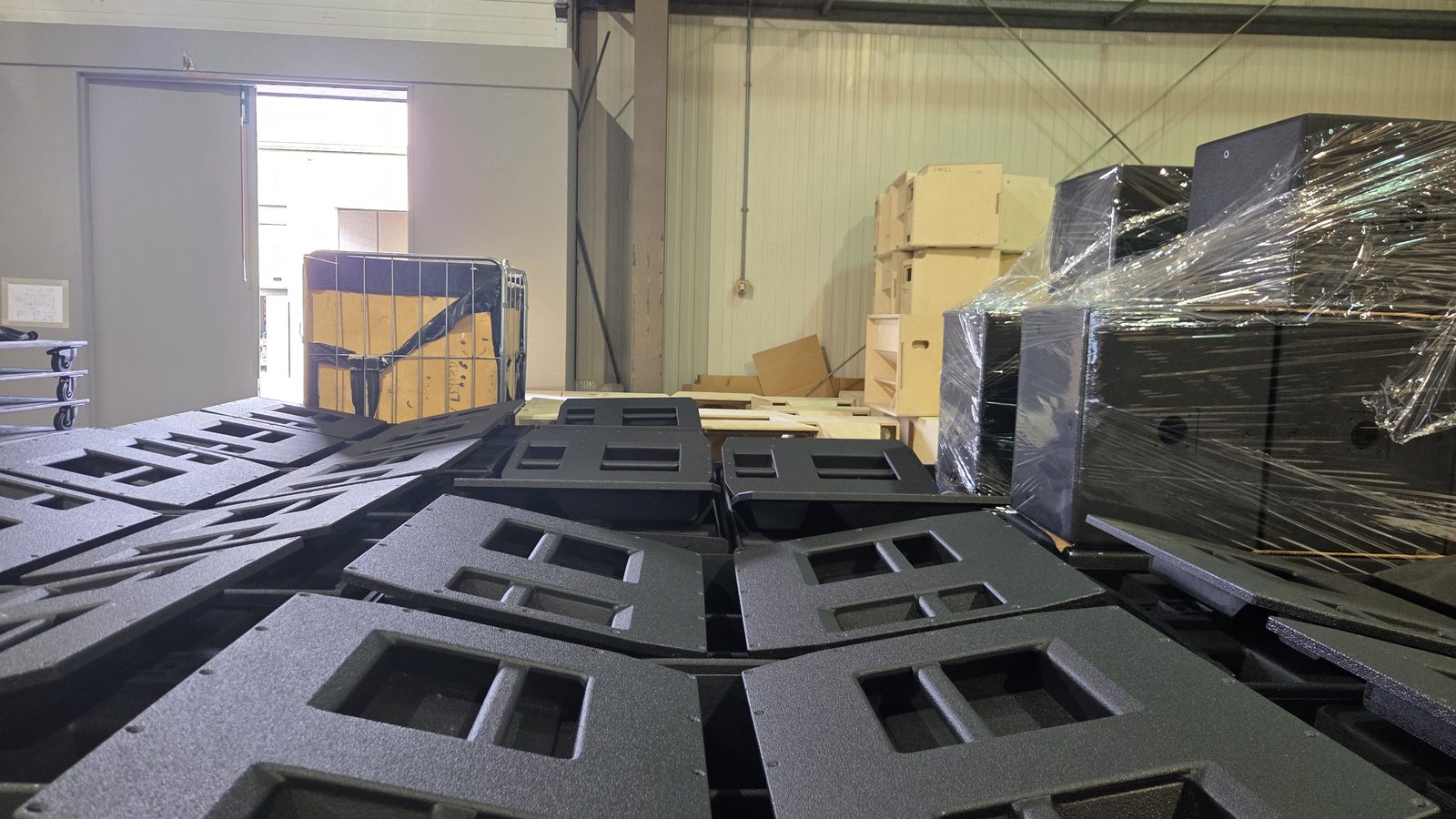 Finished commercial speaker cabinets wrapped and packed for international freight from the UK.
